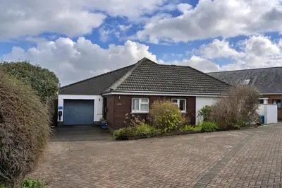 a house with a garage and a driveway at Finest Retreats - Gwelmor in Widemouth Bay