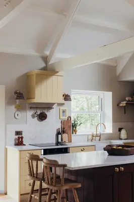 a kitchen with two chairs and a counter top at The Old Piggery, countryside barn with hot tub in Leedstown