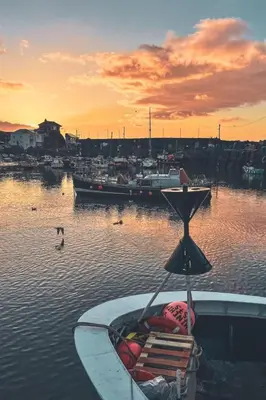 a boat sitting in the water at a harbor at Holiday Home Shanty Cottage by Interhome in Mevagissey
