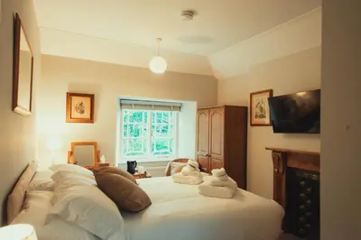 a bedroom with a bed with towels on it at The Falcon Inn in Saint Mawgan