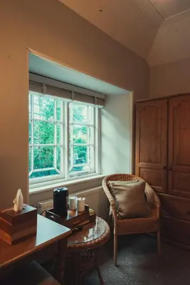 a room with a desk and a chair and a window at The Falcon Inn in Saint Mawgan