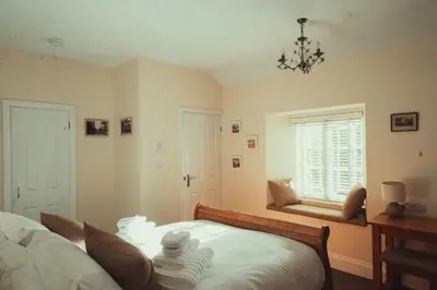 a bedroom with a bed and a window at The Falcon Inn in Saint Mawgan