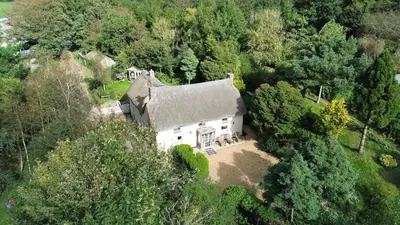 an overhead view of a large white house in the woods at Plenteth in Truro
