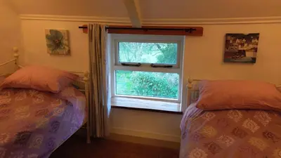 a bedroom with two beds and a window at Plenteth in Truro
