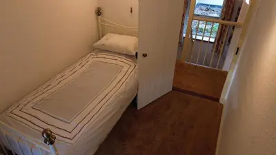 a small bedroom with a small bed in a room at Plenteth in Truro