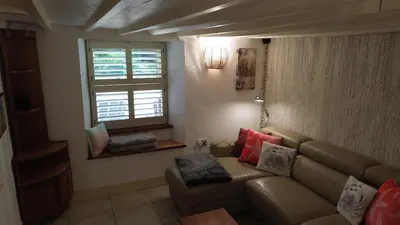 a living room with a couch and a window at Plenteth in Truro