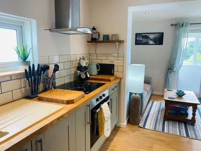 a kitchen with a stove and a counter top at Hideaway Cottage in Polperro