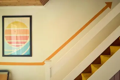 a staircase with an orange line on the wall at Little Pol in Saint Columb Road Station