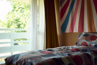a bedroom with a bed and a window with a flag at Little Pol in Saint Columb Road Station