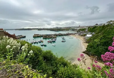 a group of boats in the water near a beach at 1 Bed in Newquay oc-o33805 in Newquay