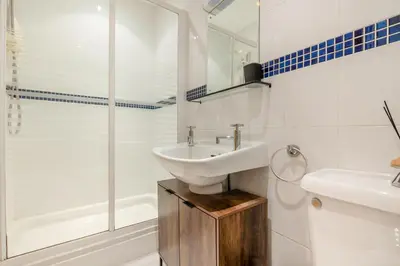 a white bathroom with a sink and a shower at 1 Bed in Newquay oc-o33805 in Newquay