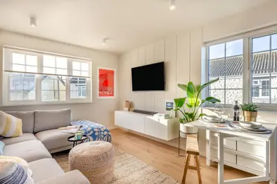 a living room with a couch and a table at 2 Bed in Trevarrian oc-c33855 in Mawgan Porth