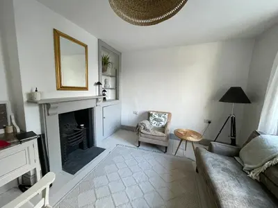a living room with a couch and a fireplace at The Locker, 2 bed apartment in Falmouth in Falmouth