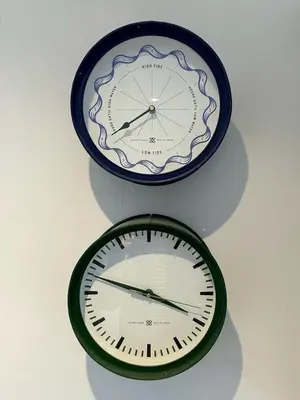 two clocks are hanging on a wall at The Locker, 2 bed apartment in Falmouth in Falmouth