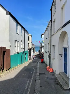 an empty street in an alley with buildings at The Locker, 2 bed apartment in Falmouth in Falmouth