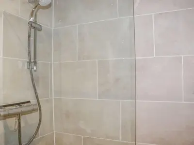 a shower with a shower head in a bathroom at Lannlyvri Lodge in Bodmin