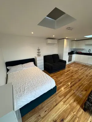 a bedroom with a bed and a couch at Private Retreat Hot Tub Fire Pit Patio Romantic in Morval