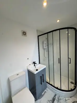 a bathroom with a shower and a toilet and a sink at Private Retreat Hot Tub Fire Pit Patio Romantic in Morval