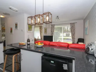 a kitchen with a red couch and a counter top at Westview in Liskeard