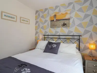 a bedroom with a bed and a geometric wall at Westview in Liskeard