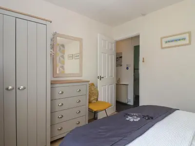 a bedroom with a bed and a dresser and a mirror at Westview in Liskeard