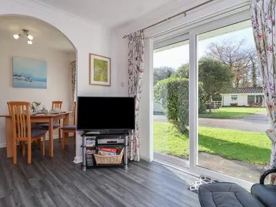 a living room with a television and a dining room table at Westview in Liskeard