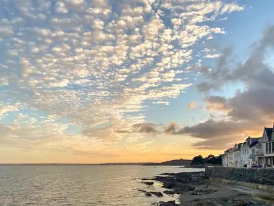 a cloudy sky over a body of water at Shearwaters in Truro