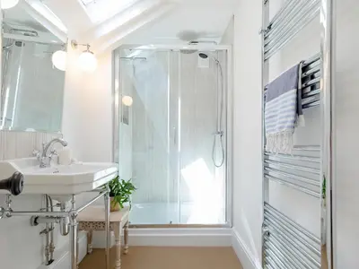a bathroom with a shower and a sink at Cellars Cottage in Porthscatho