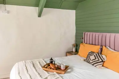a bed with a tray of food on it at Blue Skies // Porth // Newquay in Newquay