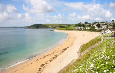 a view of a beach with people walking on it at The Quaker Hall - Private Deck - Stunning Views in Falmouth