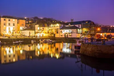 a harbor at night with boats in the water at The Quaker Hall - Private Deck - Stunning Views in Falmouth
