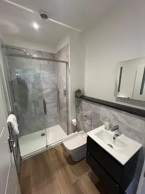 a bathroom with a shower and a toilet and a sink at 1 Bed Apartment in Town Centre in Newquay