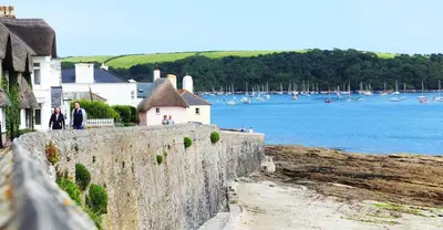 a group of people standing on a wall near a body of water at 'Langton' - Best Views in Falmouth! in Falmouth