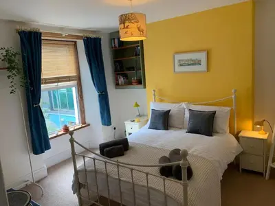 a bedroom with a bed with a teddy bear on it at 'Langton' - Best Views in Falmouth! in Falmouth