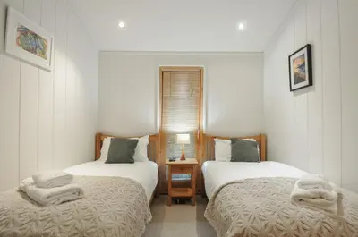 a bedroom with two beds with towels on them at 2 Streamside in Looe