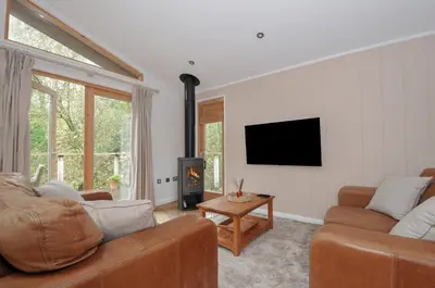 a living room with two couches and a tv at 2 Streamside in Looe