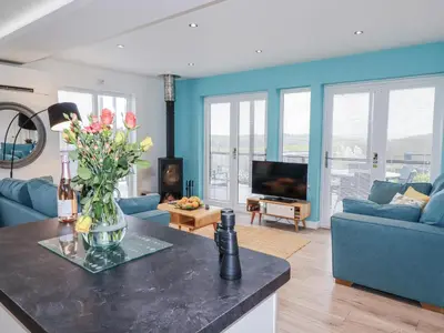 a living room with a vase of flowers on a counter at Adelaide in Redruth