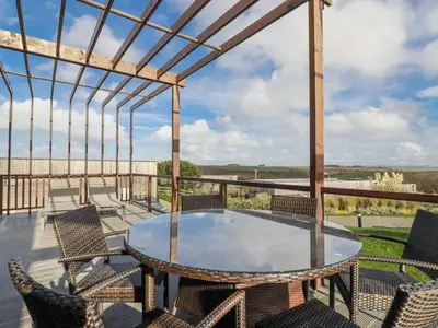 a patio with a table and chairs on a deck at Adelaide in Redruth