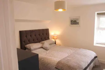 a bedroom with a large bed in a room at Minutes from the beach and town! in Falmouth