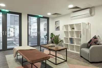 a living room with a couch and a table at Contemporary Student-Only Apartments at The Quarry, Falmouth in Falmouth