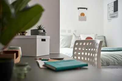 a room with a desk with a laptop and a bed at Contemporary Student-Only Apartments at The Quarry, Falmouth in Falmouth