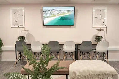 a waiting room with a table and chairs at Contemporary Student-Only Apartments at The Quarry, Falmouth in Falmouth