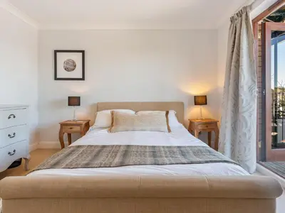 a bedroom with a large bed with two night stands at Troy Court in Fowey