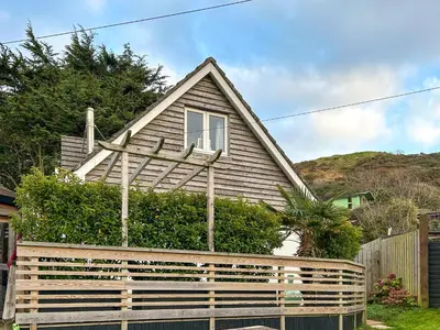 a house with a wooden fence in front of it at Kosel Mor in Porthtowan