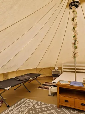 a room with a tent with a bed and a table at I do glamping penhallow campsite Ltd in Truro