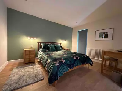 a bedroom with a bed and a desk at Seafell in Forrabury