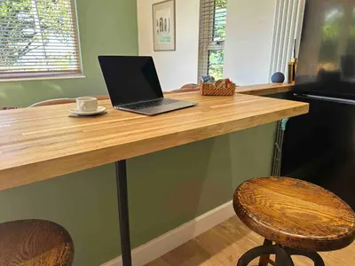 a desk with a laptop computer on top of it at Seafell in Forrabury