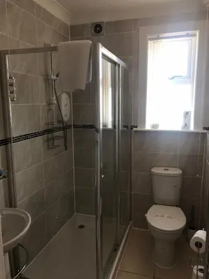 a bathroom with a shower and a toilet and a sink at Chy an Gwedhen in St Ives