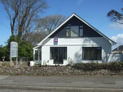 a white house with a black roof at Chy an Gwedhen in St Ives