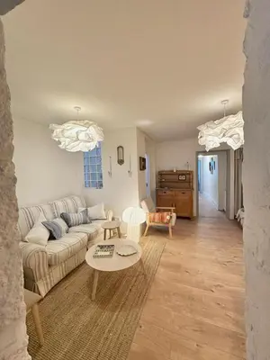 a living room with a couch and a table at Heart of St Ives with parking - 2 bedrooms in St Ives